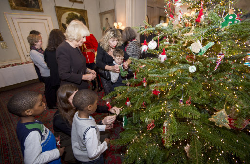 The Duchess of Cornwall decorates the Clarence House Christmas tree with the help of children supported by Helen & Douglas House and The London Taxi Drivers' Fund for Underprivileged Children, 2015.