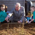 The Prince of Wales talks to pupil Imogen (right) and Avalyn during a visit to Bletchingdon Parochial Church of England School on the Bletchingdon Estate Development in Oxfordshire, 2019