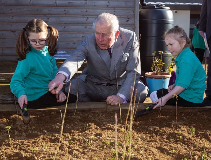 The Prince of Wales talks to pupil Imogen (right) and Avalyn during a visit to Bletchingdon Parochial Church of England School on the Bletchingdon Estate Development in Oxfordshire, 2019