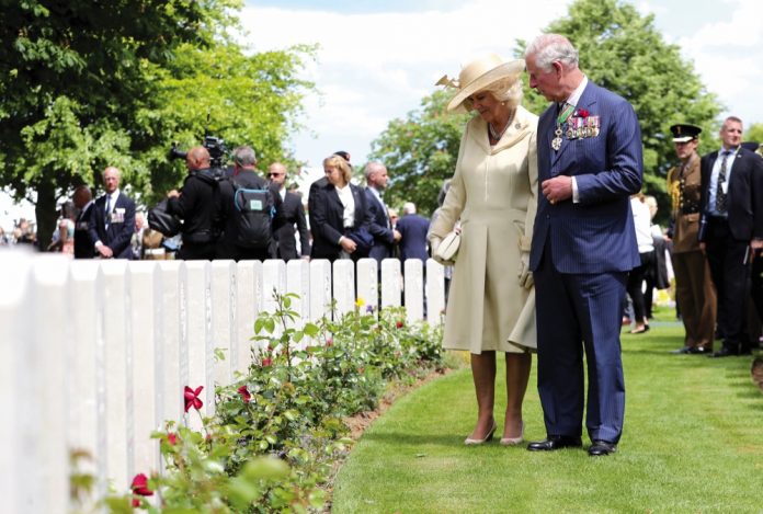 The Prince of Wales and Duchess of Cornwall looking at graves during the Royal British Legion's Service of Remembrance, at the Commonwealth War Graves Commission Cemetery, in Bayeux, France, as part of commemorations for the 75th anniversary of the D-Day landings.