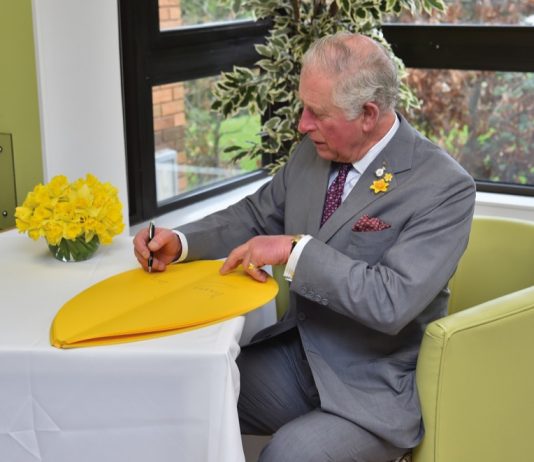 The Prince of Wales Visits Wales The Prince of Wales signs a petal as part of the Great Daffodil Appeal during a visit to the Marie Curie Hospice in Cardiff and the Vale, Wales.