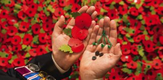 The Queen to Mark 100th Anniversary of the Poppy Factory Army veteran Shane Crowhurst pieces together a paper poppy at the Royal British Legion Poppy Appeal in Aylesford, Kent, which is one of the thousands of paper poppies that will be recycled through Sainsbury's after Armistice Day this year, 2014