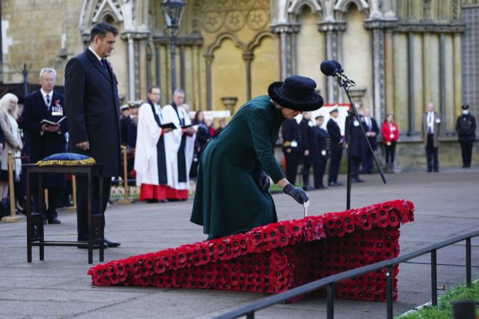 The Duchess of Cornwall places a memorial cross during a service to remember the war dead on Armistice Day at the 93rd Field of Remembrance at Westminster Abbey in London, which has been held in the grounds of the abbey since November 1928. November 11, 2021.
