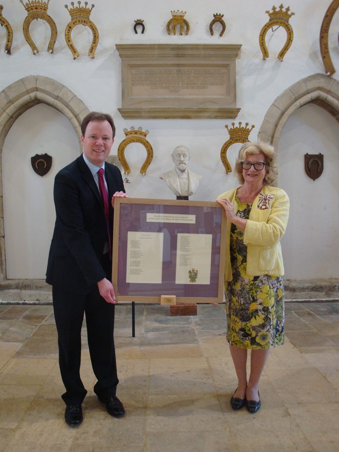Henry Dawe presenting a framed copy of his Jubilee Poem to the Lord-Lieutenant, Dr Sarah Furness, at Oakham Castle. The small box attached to the bottom of the frame contains a USB stick which will enable a member of staff to show the video of the poem to The Queen on a computer or television set.