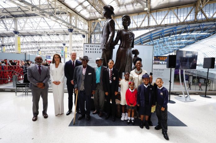 The Duke and Duchess of Cambridge, accompanied by Baroness Floella Benjamin, Windrush passengers Alford Gardner and John Richards and children at the unveiling of the National Windrush Monument at Waterloo Station, to mark Windrush Day. The statue - of a man, woman and child in their Sunday best standing on top of suitcases - was designed by the Jamaican artist and sculptor Basil Watson. June 2022.