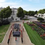 Members of the Royal Navy direct the State Gun Carriage carrying the coffin of Queen Elizabeth II, draped in the Royal Standard with the Imperial State Crown and the Sovereign’s orb and sceptre, as it arrives at Wellington Arch in London during the Ceremo