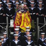 Members of the Royal Navy direct the State Gun Carriage carrying the coffin of Queen Elizabeth II, draped in the Royal Standard with the Imperial State Crown and the Sovereign’s orb and sceptre, during the Ceremonial Procession of her State Funeral as it