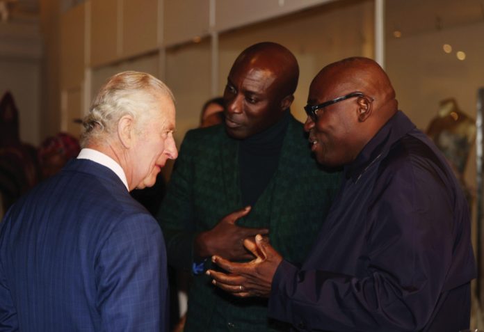 King Charles III speaks to fashion designer Ozwald Boateng, OBE (left) and Edward Kobina Enninful OBE, editor-in-chief of British Vogue (right) during his visit to the Africa Fashion exhibition at the Victoria and Albert Museum, London. November 3, 2022.