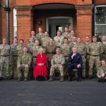 The Queen Consort, in her role as Colonel of the Grenadier Guards, poses for a group photo during a visit to Lille Barracks in Aldershot, Hampshire, where she is meeting members of the battalion, presenting medals and meeting families. Picture date: Tuesd