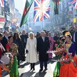 Britain’s King Charles III and Camilla, the Queen Consort visit Brick Lane in east London, Wednesday Feb. 8, 2023, to meet with charities and businesses. (Eddie Mulholland/Pool via AP)