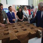 Britain’s King Charles III speaks to students in the exhibition hall for sustainability as he visits the University of East London to mark the University’s 125th anniversary and open a new frontline medical teaching hub in London, Wednesday, Feb. 8, 2023.