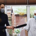 Britain’s Kate, Princess of Wales makes a pancake during a visit to the Oxford House Nursing Home in Slough, England, Tuesday, Feb. 21, 2023. (Hannah McKay/Pool Photo via AP)