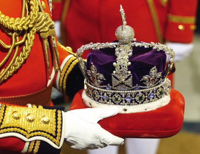 The Imperial State Crown is carried into Parliament through the Sovereigns Entrance of the Palace of Westminister for the Queen to wear during the State Opening of Parliament.