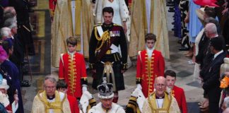 Charles III: The Coronation Year King Charles III, wearing the Imperial State Crown, leaves Westminster Abbey in central London following his coronation ceremony, May 6, 2023.