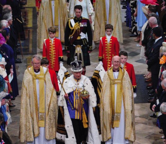 Charles III: The Coronation Year King Charles III, wearing the Imperial State Crown, leaves Westminster Abbey in central London following his coronation ceremony, May 6, 2023.