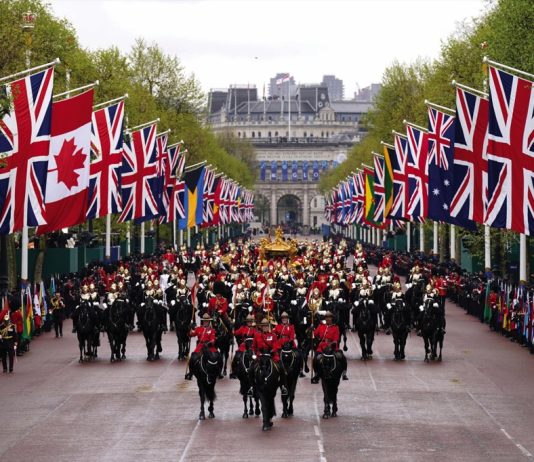 The King, accompanied by The Princess Royal, will present a new Sovereign’s Standard to The Blues and Royals The Coronation Procession travels along The Mall following the Coronation of King Charles III and Queen Camilla in London, 2023