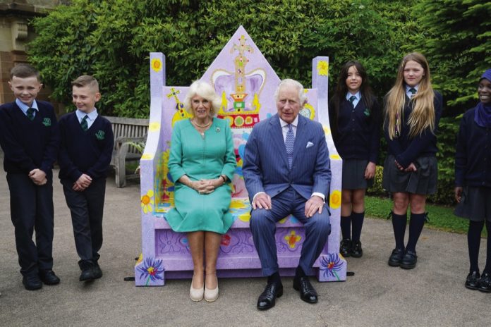 King Charles III and Queen Camilla meet pupils from Belfast's Blythefield Primary School who have taken part in Historic Royal Palaces' competition to design Coronation benches at Hillsborough Castle, Co Down during a two day visit to Northern Ireland, May 24, 2023.