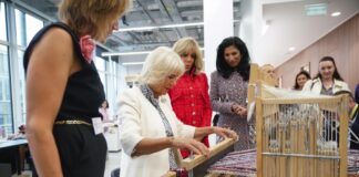 The Queen becomes Honorary Liveryman of the Worshipful Company of Fan Makers The Queen, watched by Brigitte Macron (second right), and Global Chief Executive officer of Chanel, Leena Nair (right), tries her hand at weaving tweed on a traditional loom in the Maison Lesage, during her visit to la Galerie du 19M in Paris, on day two of the State Visit to France. September 21, 2023.