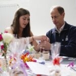 The Duke of Edinburgh, in his role as Patron of the Duke of Edinburgh’s Award (DofE) charity packages up cupcakes with a student during a visit to Brighton Hove and Sussex Sixth Form College in Brighton, East Sussex, to hear from young people making a dif