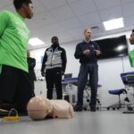 The Duke of Edinburgh, in his role as Patron of the Duke of Edinburgh’s Award (DofE) charity, talks to students demonstrating CPR during a visit to Brighton & Hove Albion Football Club’s Elite Performance Centre in Brighton, East Sussex, to meet young foo