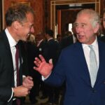 King Charles III meets Royal Photographer Chris Jackson during a reception to thank those involved in the planning and arrangements following the death of Queen Elizabeth II and the Coronation at Buckingham Palace, London, October 19, 2023.