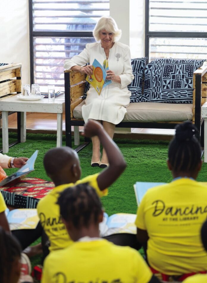 Queen Camilla reads a book in the children's reading space (Chekechea), during a session with Book Aid International, as she visits the Eastlands Library in Nairobi, on day one of the State Visit to Kenya. October 31, 2023.