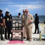 King Charles III meets members of Flipflopi, a movement which aims to end single use plastic, transforming and upcycling litter to preserve the marine and environment and create products rooted in heritage, during a visit to Early Birds Banda, a community
