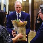 Prince William receives a bouquet of flowers for his wife Catherine, Princess of Wales, during his visit at the Western Marble Arch Synagogue, in London, Feb. 29, 2024.