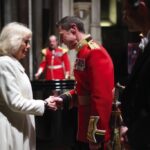 Queen Camilla shakes hands with Captain Robert Smith Director of Music for the Grenadier Guards Band during a musical evening at Salisbury Cathedral in Wiltshire, February, 2024.