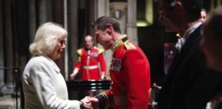 Her Majesty The Queen to Mark Holocaust Memorial Day Queen Camilla shakes hands with Captain Robert Smith Director of Music for the Grenadier Guards Band during a musical evening at Salisbury Cathedral in Wiltshire, February, 2024.