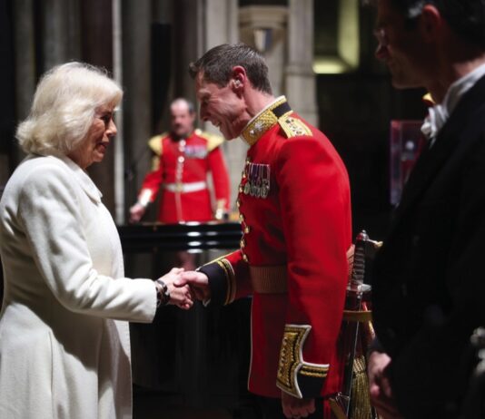 Her Majesty The Queen to Mark Holocaust Memorial Day Queen Camilla shakes hands with Captain Robert Smith Director of Music for the Grenadier Guards Band during a musical evening at Salisbury Cathedral in Wiltshire, February, 2024.