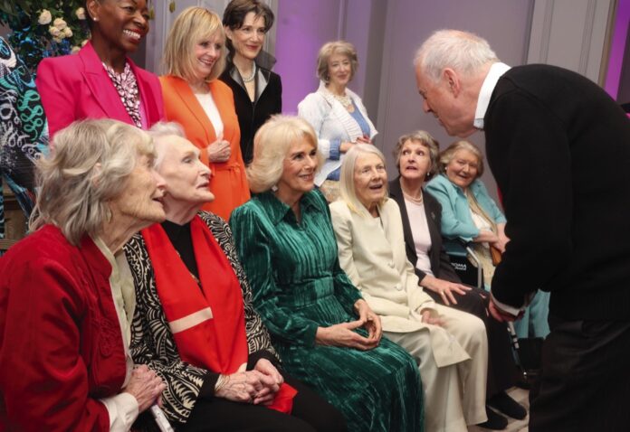 Gyles Brandreth speaks to Queen Camilla alongside Floella Benjamin, Twiggy Lawson, Harriet Walter, Maureen Lipman (left to right front row) Virginia McKenna, Sian Phillips, Vanessa Redgrave, Penelope Keith and Patricia Routledge at a Celebration of Shakespeare event at Grosvenor House, central London, marking 400 years since the first Shakespeare folio. February 14, 2024.