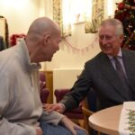 His Majesty spends time with a patient on a previous visit to Sue Ryder Leckhampton Court Hospice as during his Patronage as Prince of Wales. Credit: Rob Lacey