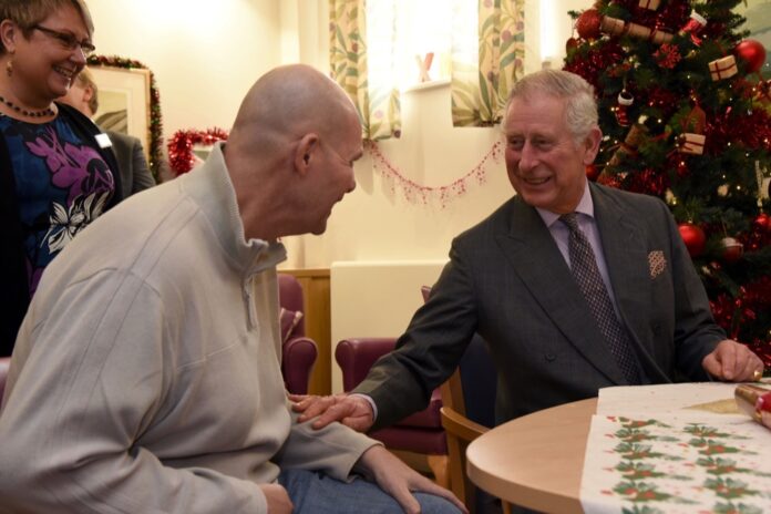 His Majesty spends time with a patient on a previous visit to Sue Ryder Leckhampton Court Hospice as during his Patronage as Prince of Wales. Credit: Rob Lacey